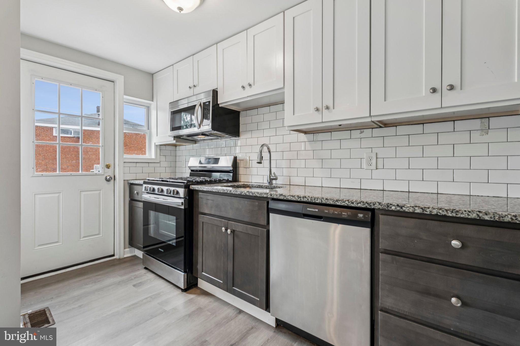 7838 St Boniface Lane Dundalk, MD 21222 - Photo 10 of 37 a kitchen with granite countertop cabinets stainless steel appliances and a sink