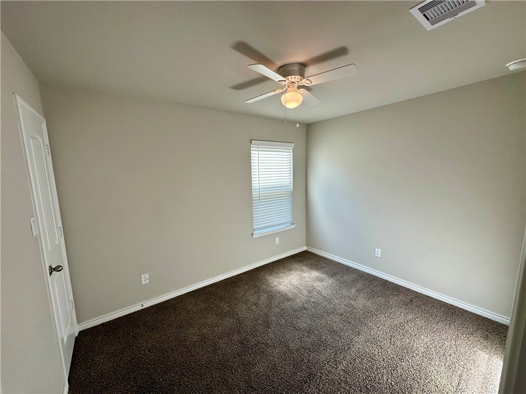 2110 Chief Street Bryan, TX 77807 - Photo 11 of 16 Spare room with dark carpet and ceiling fan