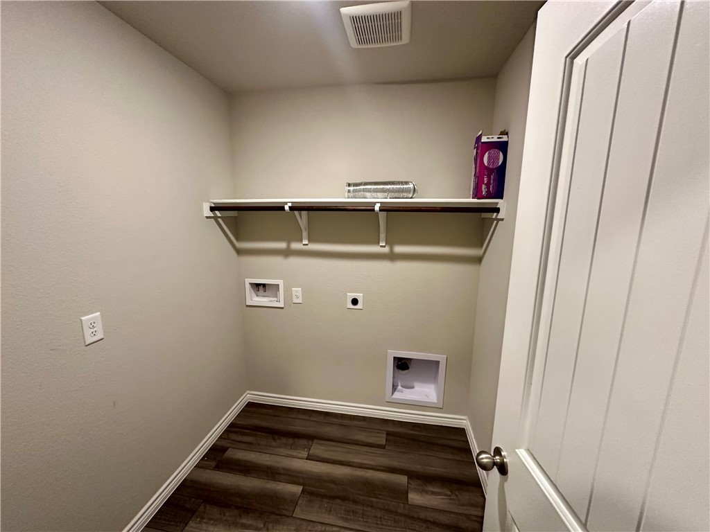 2110 Chief Street Bryan, TX 77807 - Photo 12 of 16 Laundry room featuring washer hookup, electric dryer hookup, and dark wood-type flooring