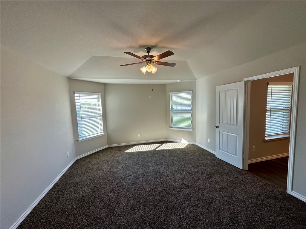 2110 Chief Street Bryan, TX 77807 - Photo 6 of 16 Spare room featuring healthy amount of natural light, dark colored carpet, and ceiling fan