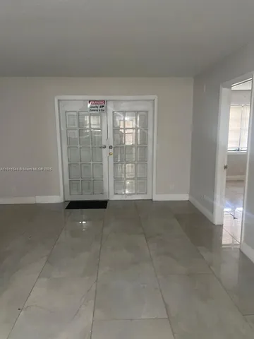 a view of an empty room with glass door