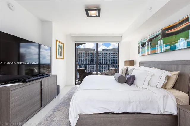 a bedroom with a bed and a large window