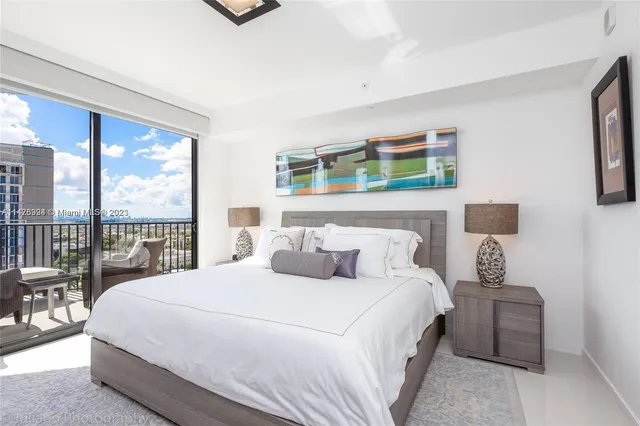 a bedroom with a flat screen tv and a bed