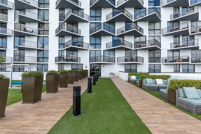 a living room with furniture and large windows