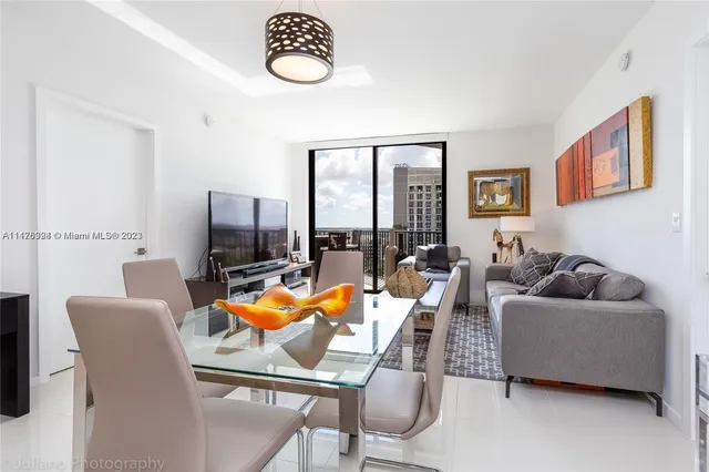 a living room with furniture and a floor to ceiling window