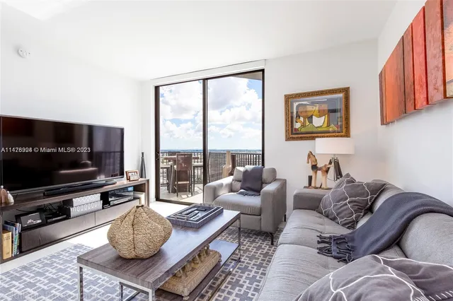 a living room with lots of furniture and a flat screen tv