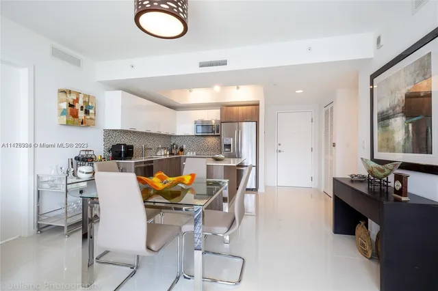 a bathroom with a sink vanity granite shower and a mirror
