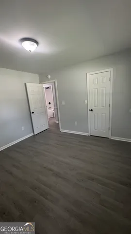 an empty room with wooden floor