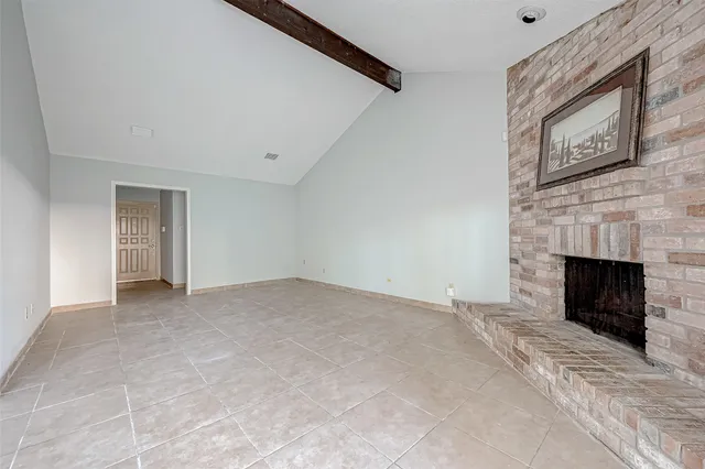 a view of an empty room with a fireplace
