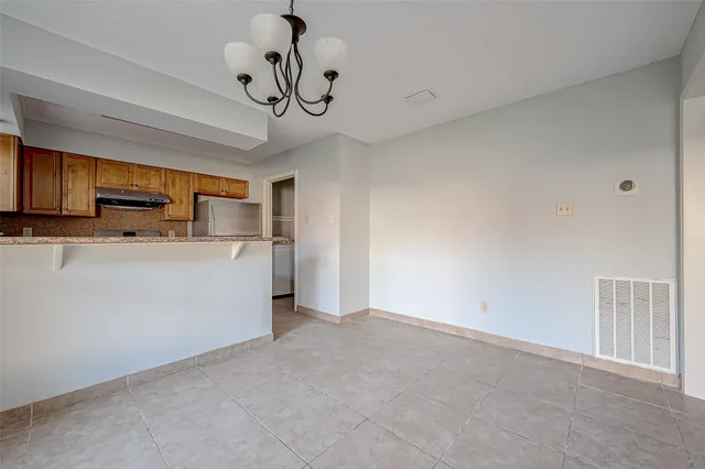 a view of a kitchen with a sink and dishwasher a refrigerator with wooden floor