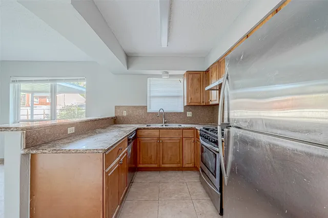 a kitchen with a sink stove and refrigerator