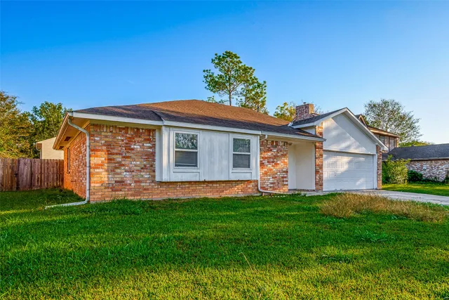 a front view of house with a garden