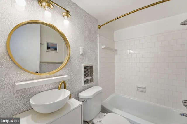 a bathroom with a toilet a sink and a mirror