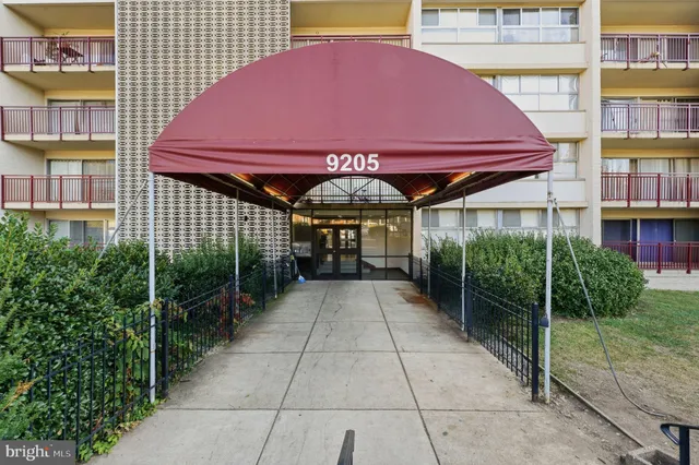 a view of a patio with a table and chairs under an umbrella