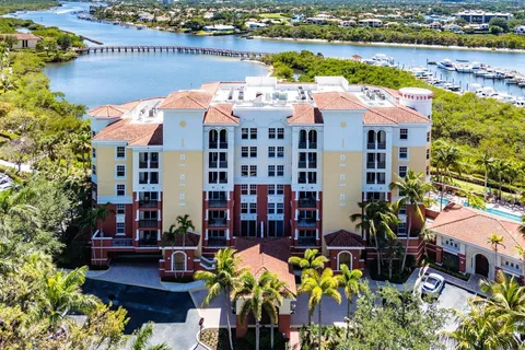 a aerial view of a house with outdoor seating space and lake view