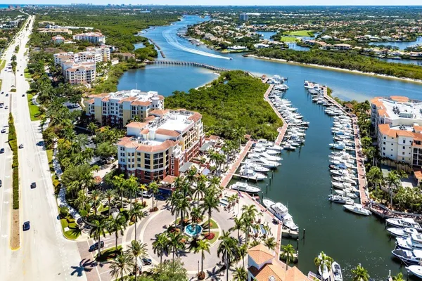 an aerial view of lake and residential houses with outdoor space
