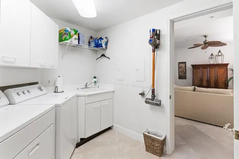 a bathroom with a shower curtain a sink a mirror and a toilet