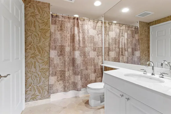 a bathroom with a sink toilet and shower