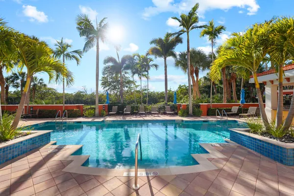 a view of a swimming pool with a patio and a garden