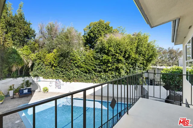 a view of a pathway of a house with wooden stairs