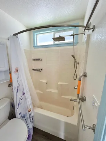 a bathroom with a bathtub and a shower