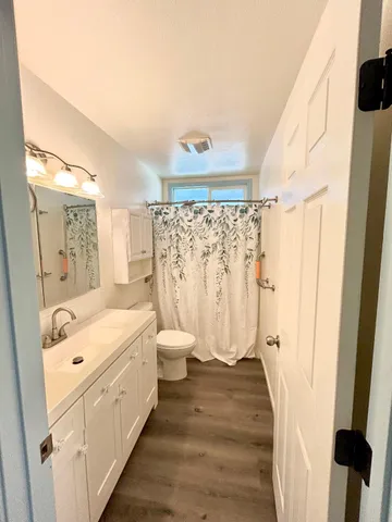 a bathroom with a double vanity sink toilet and shower
