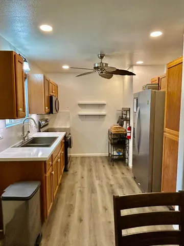 a kitchen with stainless steel appliances a sink stove and refrigerator