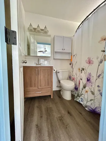 a view of a kitchen with wooden floor and a sink