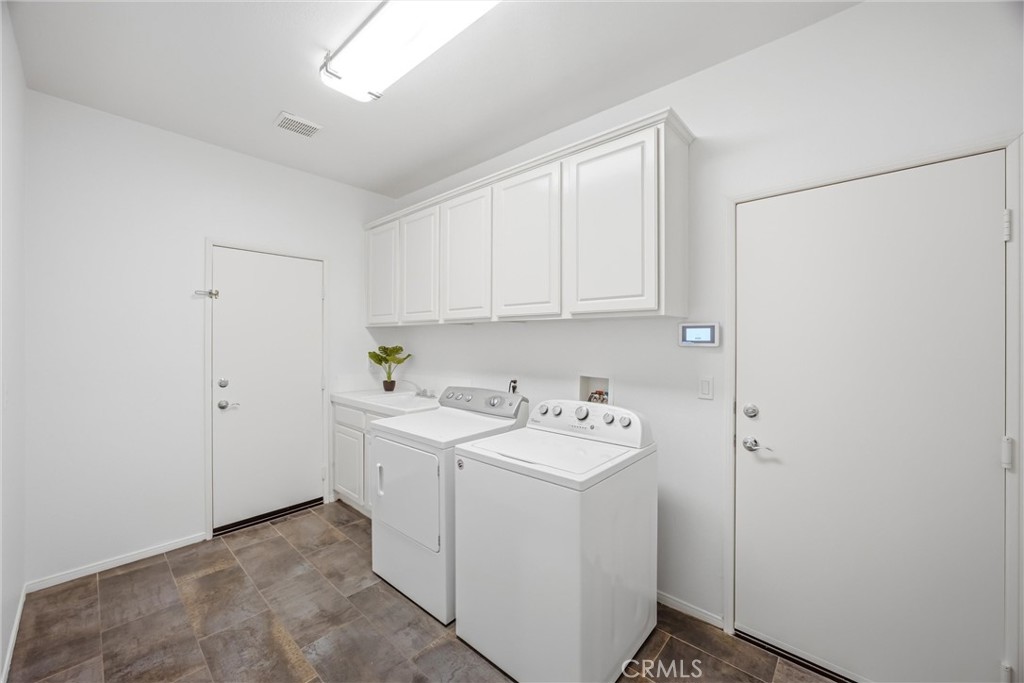 8710 Windmill Place Riverside, CA 92508 - Photo 40 of 66 a utility room with dryer and washer