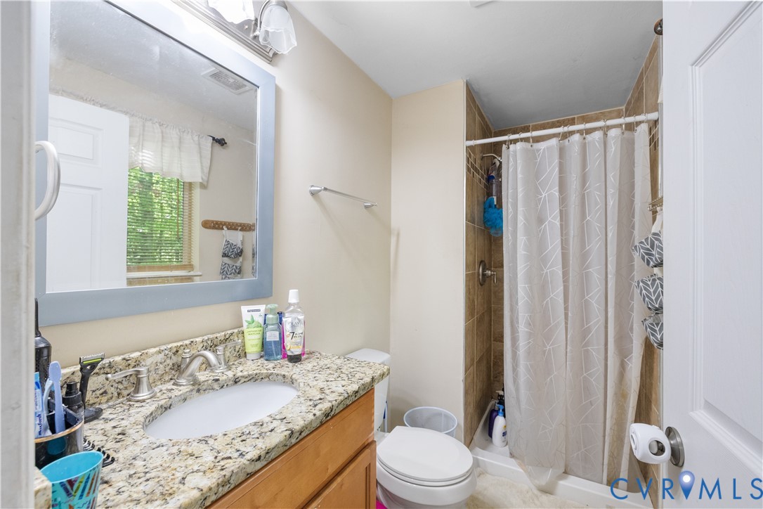 13313 Farm Crest Court Midlothian, VA 23112 - Photo 11 of 24 a bathroom with a granite countertop sink toilet and shower