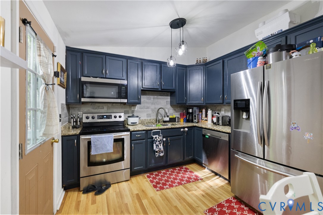 13313 Farm Crest Court Midlothian, VA 23112 - Photo 5 of 24 a kitchen with stainless steel appliances granite countertop a refrigerator a stove top oven a sink and dishwasher