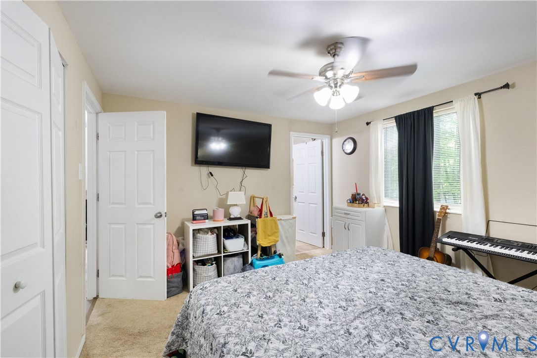 13313 Farm Crest Court Midlothian, VA 23112 - Photo 10 of 24 a bedroom with a bed and a flat screen tv