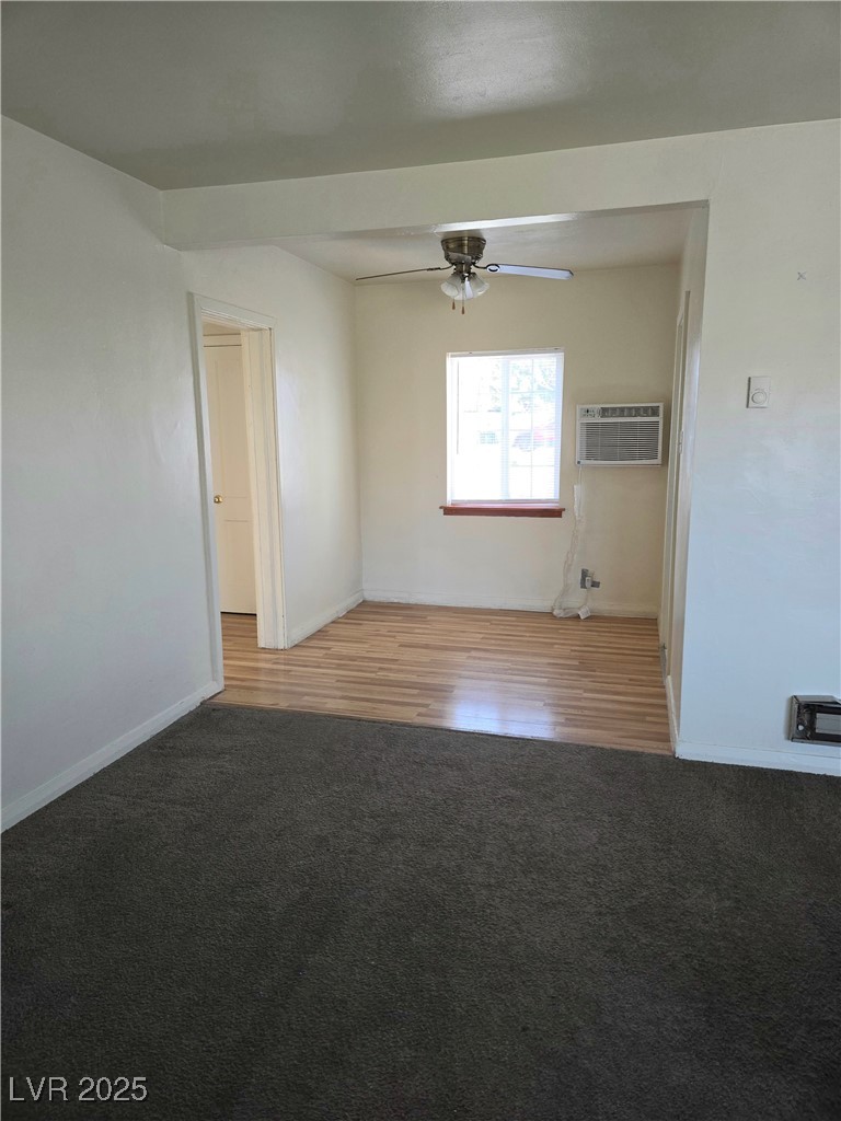 633 Nevada Way, Unit 3 Boulder City, NV 89005 - Photo 2 of 7 Carpeted empty room featuring a wall mounted AC and ceiling fan