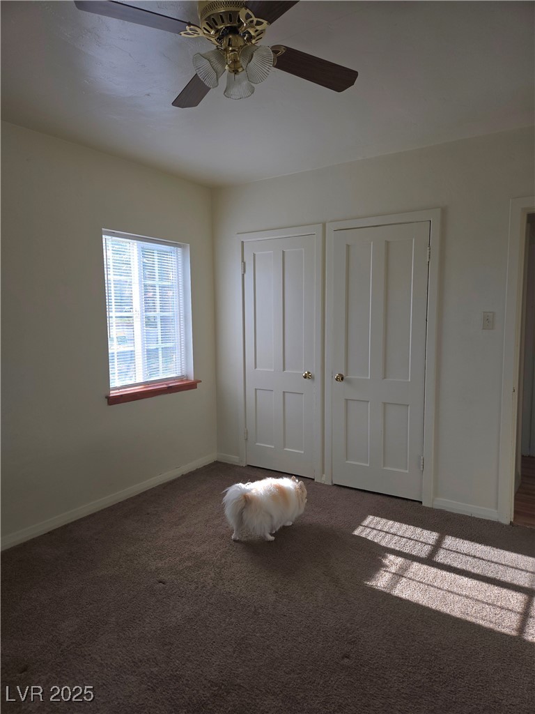 633 Nevada Way, Unit 3 Boulder City, NV 89005 - Photo 7 of 7 Bedroom featuring carpet floors, two closets, and ceiling fan