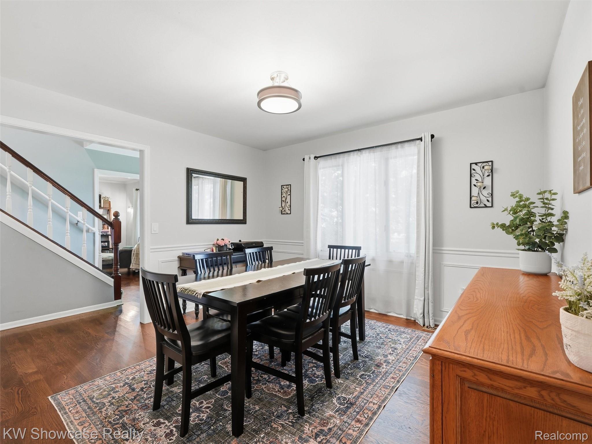 3360 Pleasant Valley Road Brighton, MI 48114 - Photo 18 of 60 Dining space featuring wood-finish flooring, white trim, and a contemporary ceiling fixture