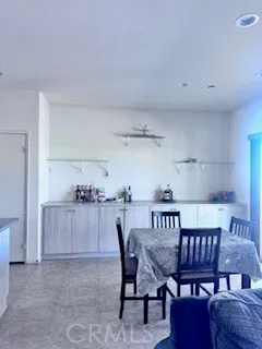 a kitchen with white cabinets and refrigerator