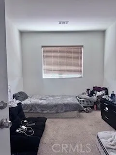 a bedroom with a bed and cabinets