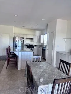 a view of kitchen and dining area with furniture