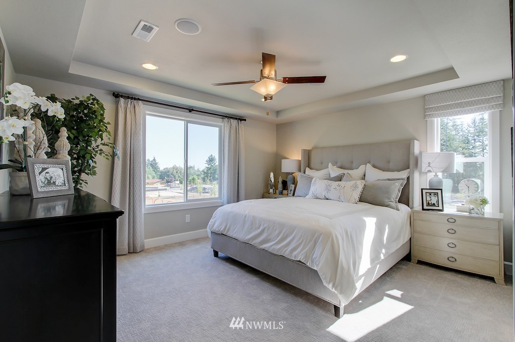 9779 Prospect Place Gig Harbor, WA 98332 - Photo 11 of 22 a bedroom with a large bed and a window
