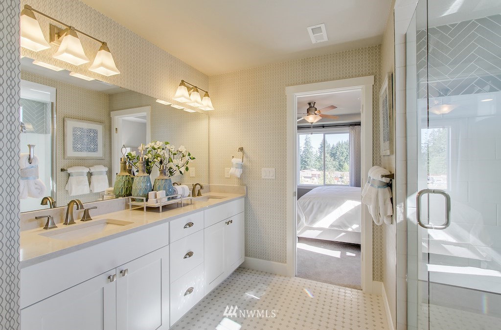 9779 Prospect Place Gig Harbor, WA 98332 - Photo 13 of 22 a en suite bathroom with a double vanity sink and a mirror