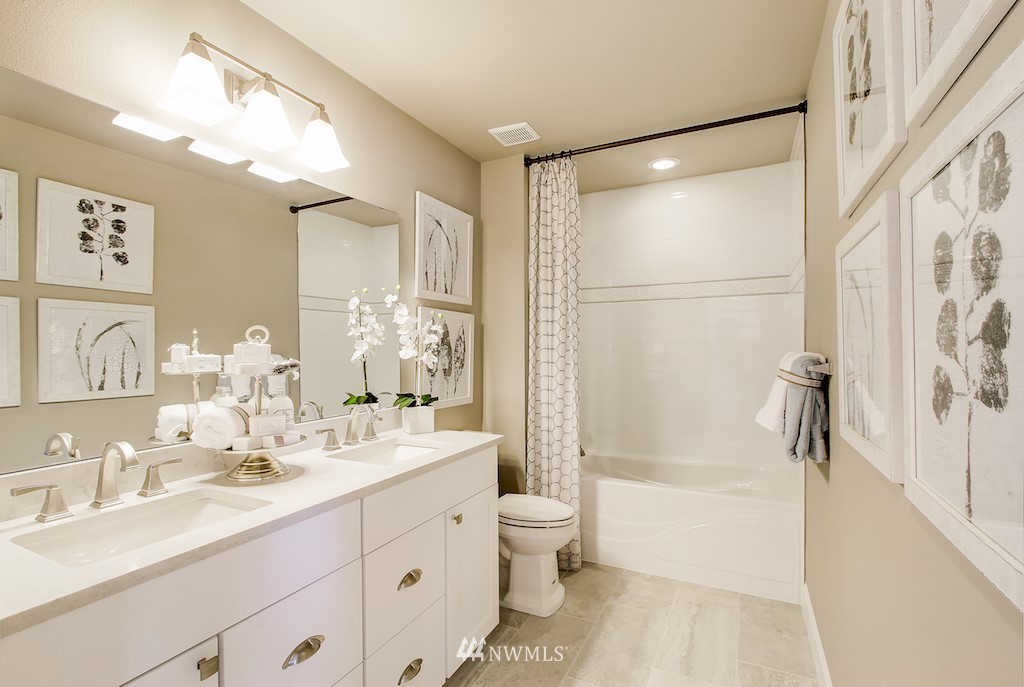 9779 Prospect Place Gig Harbor, WA 98332 - Photo 15 of 22 a bathroom with a double vanity sink mirror double vanity and bathtub