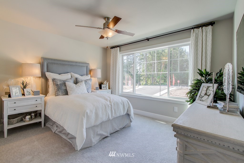9779 Prospect Place Gig Harbor, WA 98332 - Photo 16 of 22 a spacious bedroom with a bed and a large window
