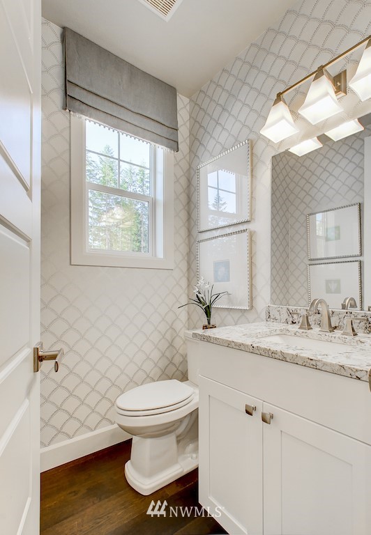 9779 Prospect Place Gig Harbor, WA 98332 - Photo 3 of 22 a bathroom with a granite countertop toilet a sink and a window