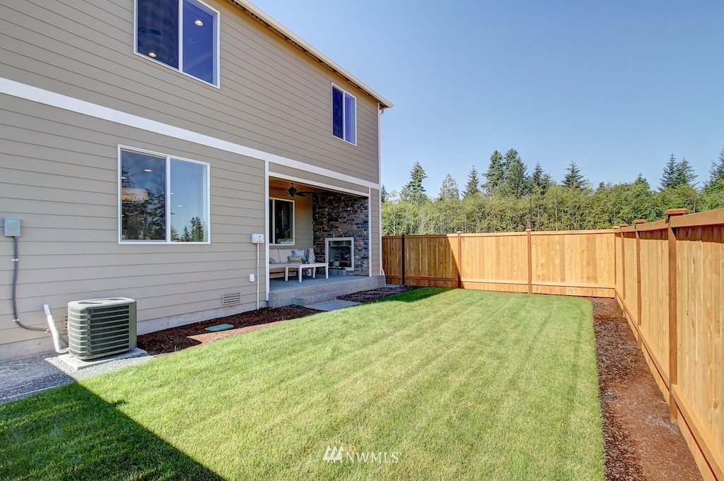 9779 Prospect Place Gig Harbor, WA 98332 - Photo 22 of 22 a view of a house with backyard and sitting area