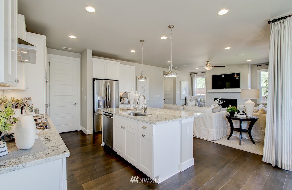 9779 Prospect Place Gig Harbor, WA 98332 - Photo 7 of 22 a large kitchen with stainless steel appliances kitchen island granite countertop a large island in the center