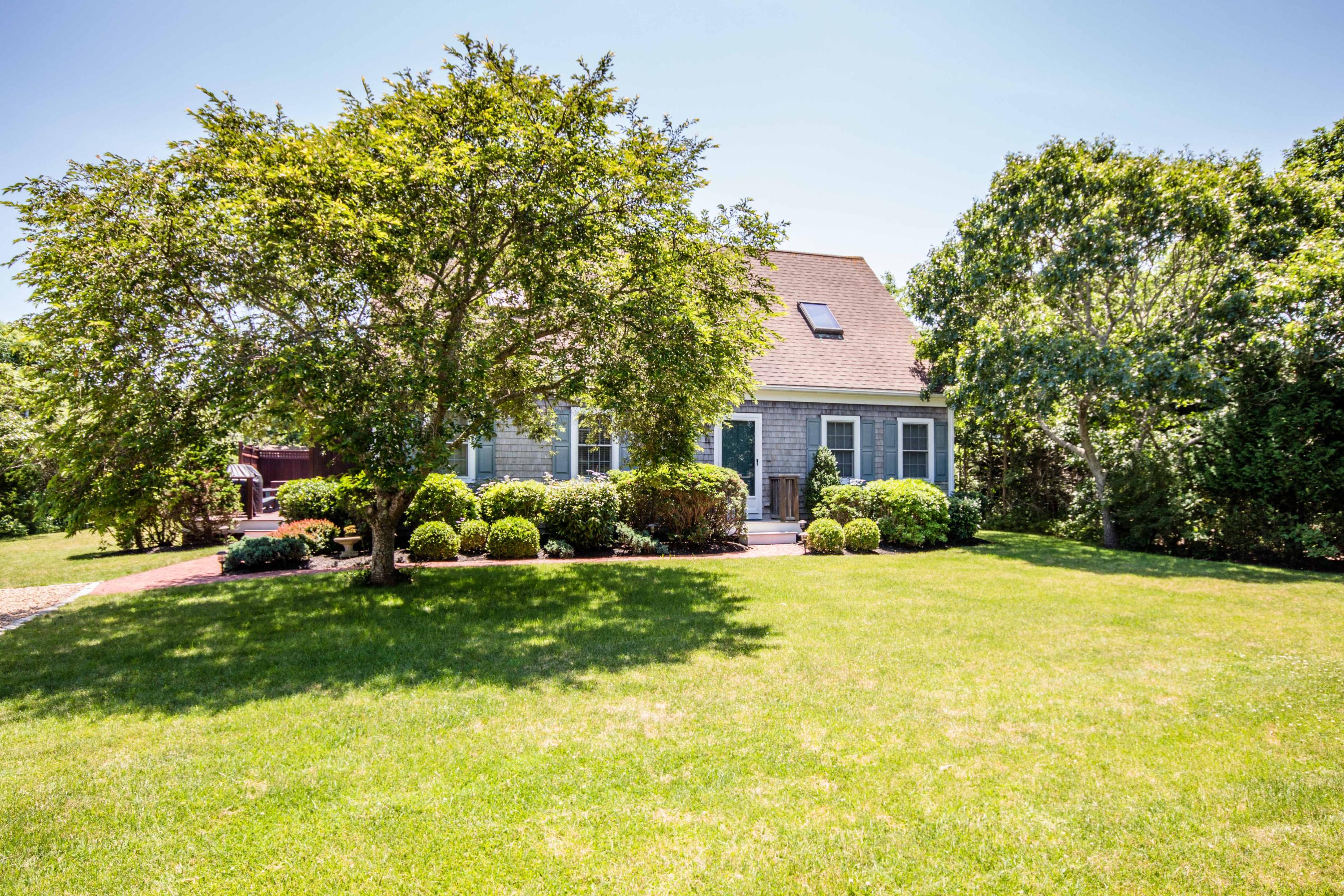 59 Schoolhouse Road Edgartown, MA 02539 - Photo 1 of 1 a view of a house with a big yard and large trees