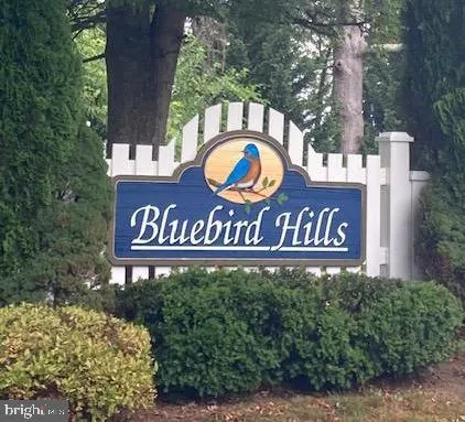 a front view of a house with swimming pool having outdoor seating