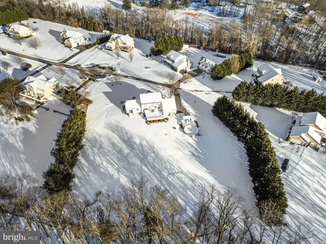 a view of a hallway with wooden floor and entryway
