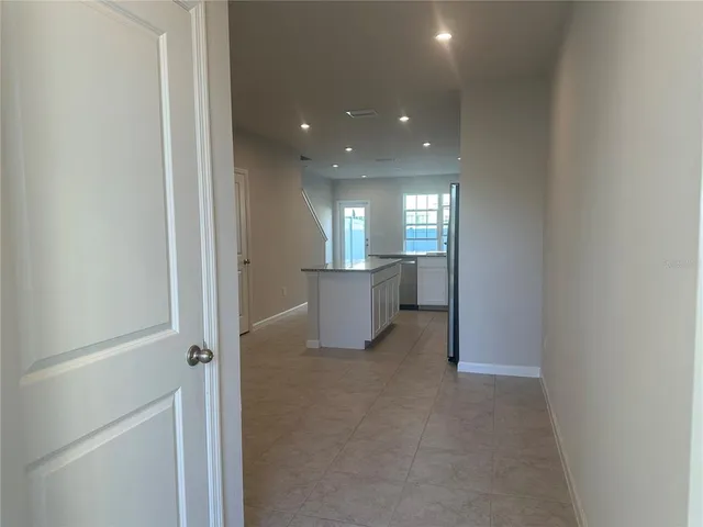 a view of a big room with wooden floor and windows