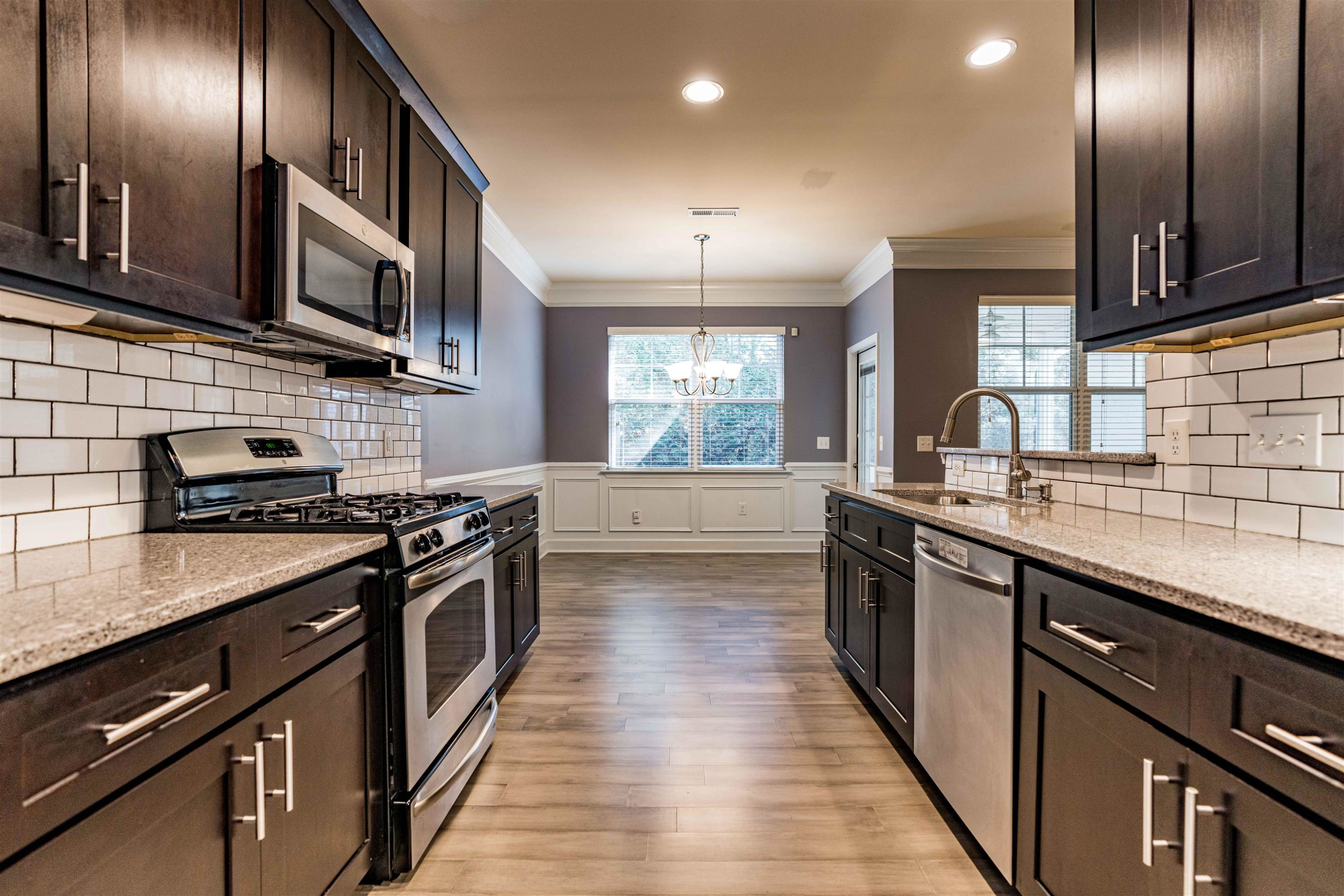 2081 Weston Green Loop Cary, NC 27513 - Photo 12 of 29 a kitchen with stainless steel appliances granite countertop a stove and a sink